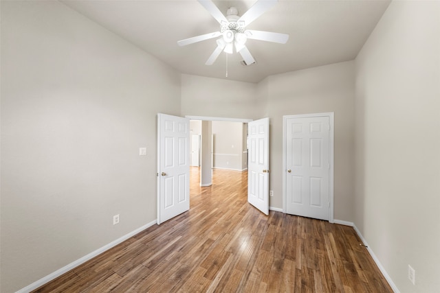 unfurnished bedroom featuring wood-type flooring and ceiling fan