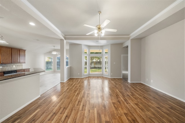 unfurnished living room with ceiling fan and hardwood / wood-style floors