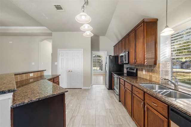 kitchen with appliances with stainless steel finishes, sink, plenty of natural light, and pendant lighting