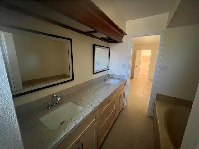 bathroom with vanity, a tub, and tile patterned floors