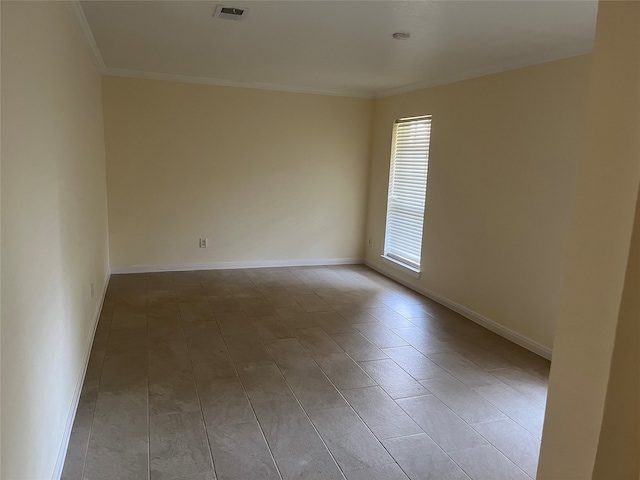 empty room featuring ornamental molding and light hardwood / wood-style flooring