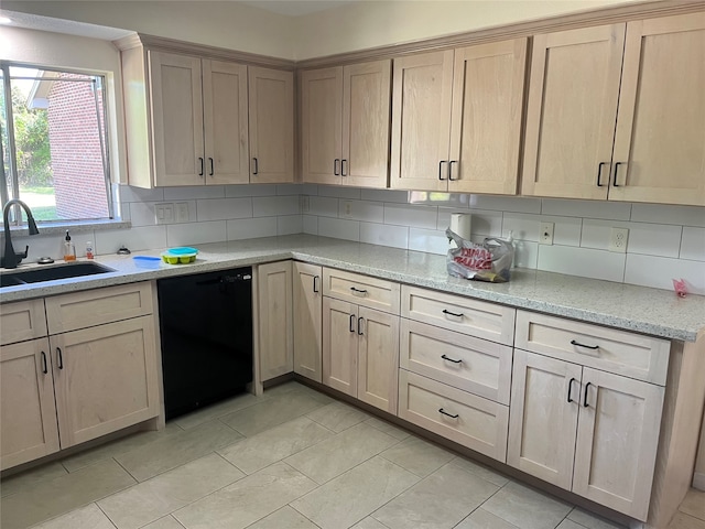 kitchen featuring tasteful backsplash, light stone countertops, dishwasher, light tile patterned flooring, and sink