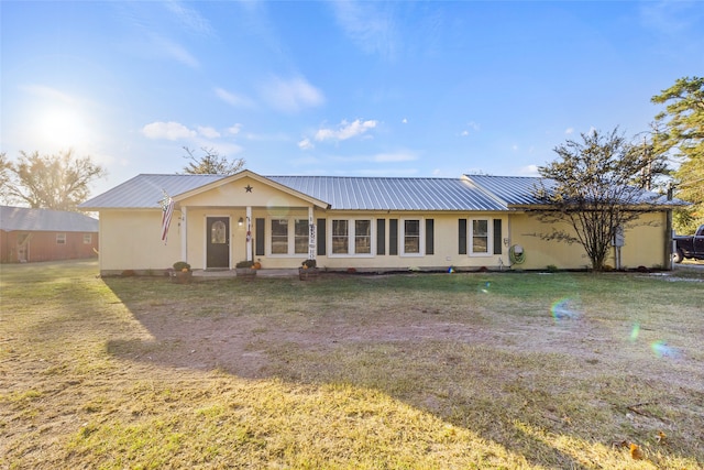 back of house with a lawn