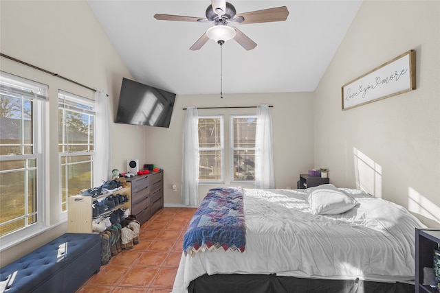 bedroom with lofted ceiling, tile patterned flooring, and ceiling fan