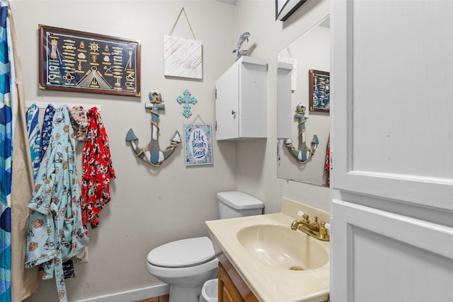 bathroom featuring toilet and vanity