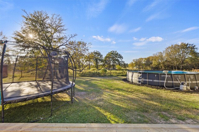 view of yard featuring a trampoline