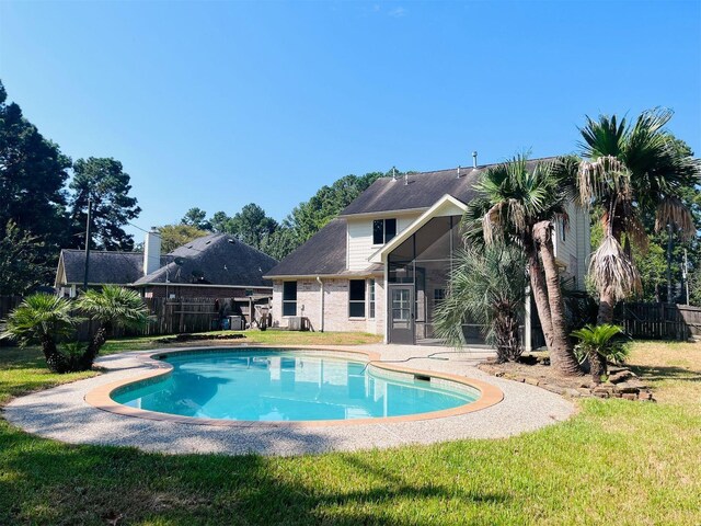 5802 Sugar Bush Dr, Magnolia, TX 77354 - view of pool with fence, a lawn, a fenced in pool, and a sunroom
