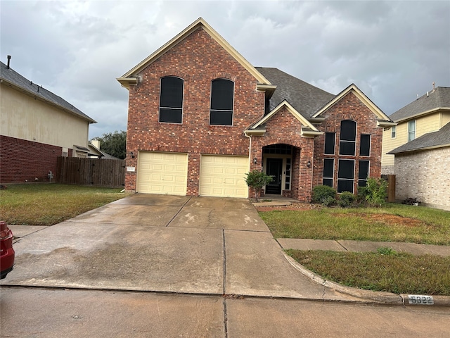 view of front property featuring a garage and a front yard