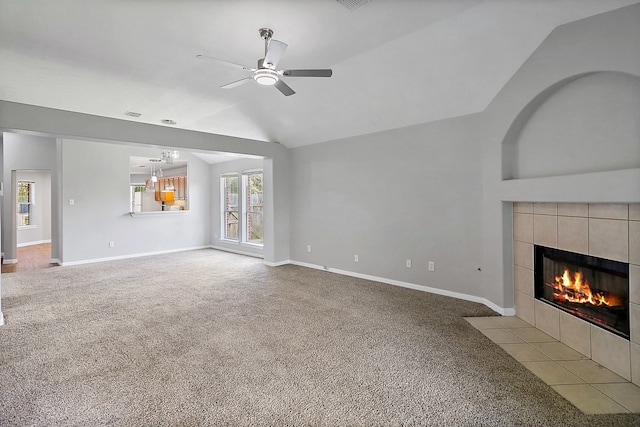 unfurnished living room featuring light carpet, ceiling fan, a fireplace, and vaulted ceiling