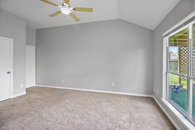 empty room featuring lofted ceiling, carpet, and ceiling fan