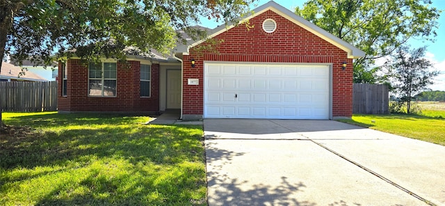 view of front of home with a front yard and a garage