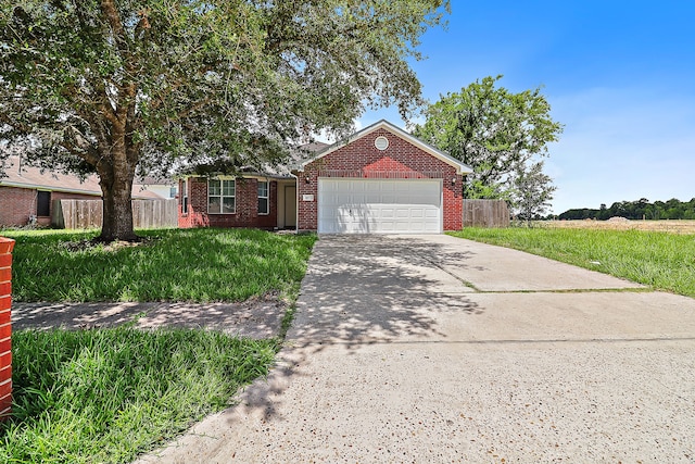 view of front of house with a front yard and a garage