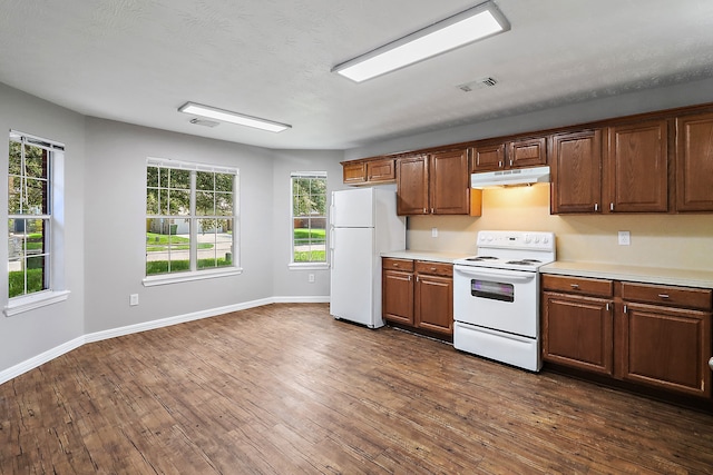 kitchen with dark hardwood / wood-style floors and white appliances