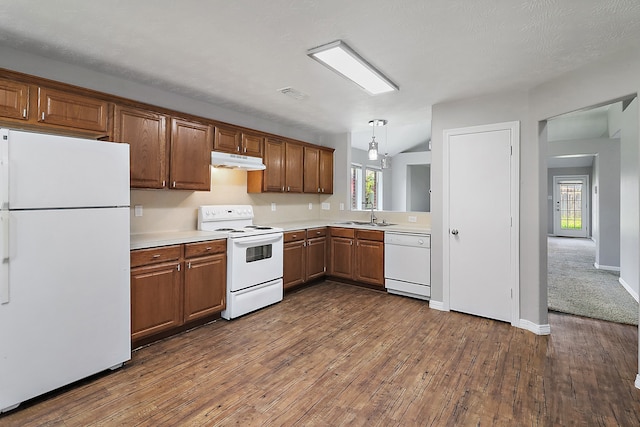 kitchen featuring dark hardwood / wood-style flooring, plenty of natural light, pendant lighting, and white appliances