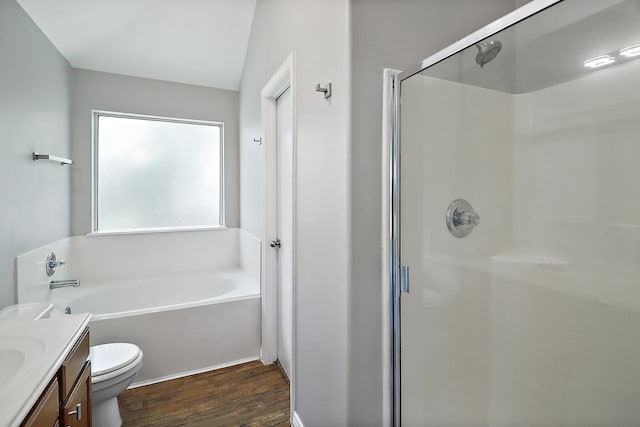 full bathroom featuring separate shower and tub, hardwood / wood-style flooring, vaulted ceiling, toilet, and vanity