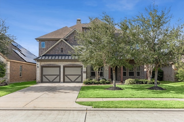 view of front of house featuring a front lawn and a garage