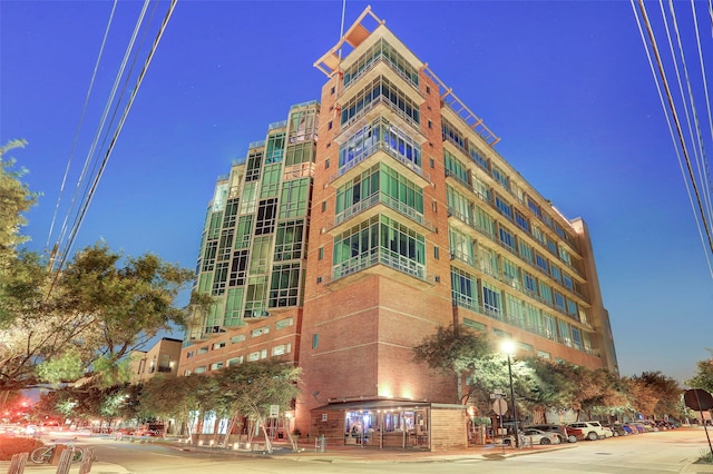 view of outdoor building at dusk