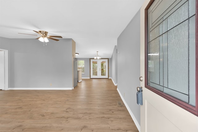 spare room featuring french doors, light wood-type flooring, and ceiling fan