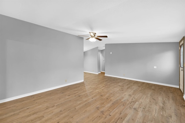 unfurnished living room with ceiling fan, vaulted ceiling, and light hardwood / wood-style floors