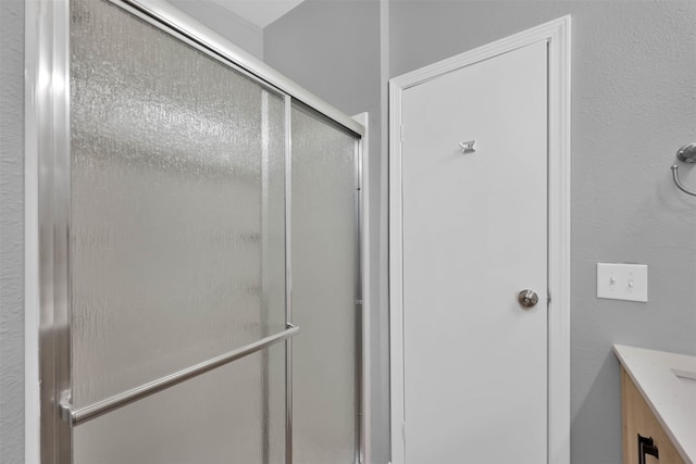 bathroom featuring vanity and an enclosed shower