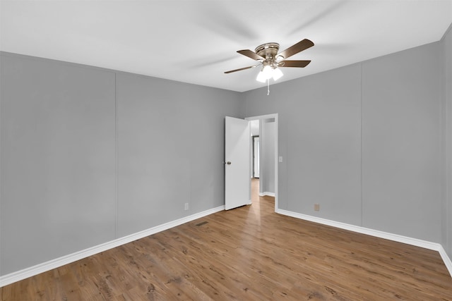 spare room with hardwood / wood-style flooring and ceiling fan