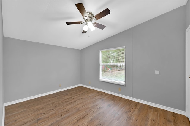 unfurnished room featuring hardwood / wood-style flooring, ceiling fan, and vaulted ceiling