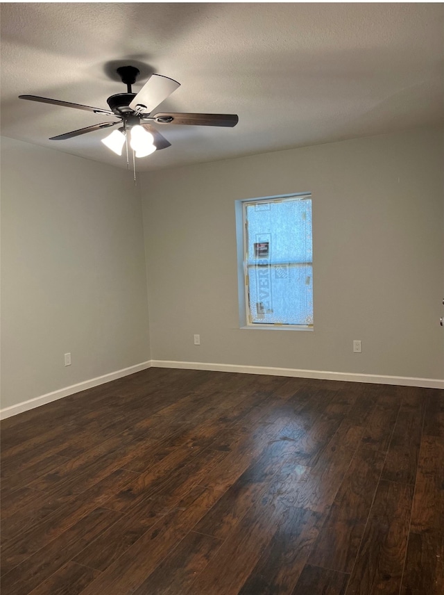 empty room featuring a textured ceiling, dark hardwood / wood-style flooring, and ceiling fan