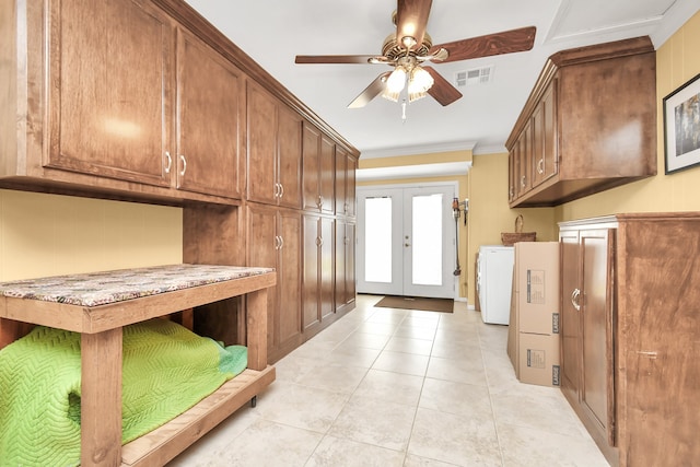 interior space featuring french doors, ornamental molding, ceiling fan, washer / clothes dryer, and light tile patterned flooring