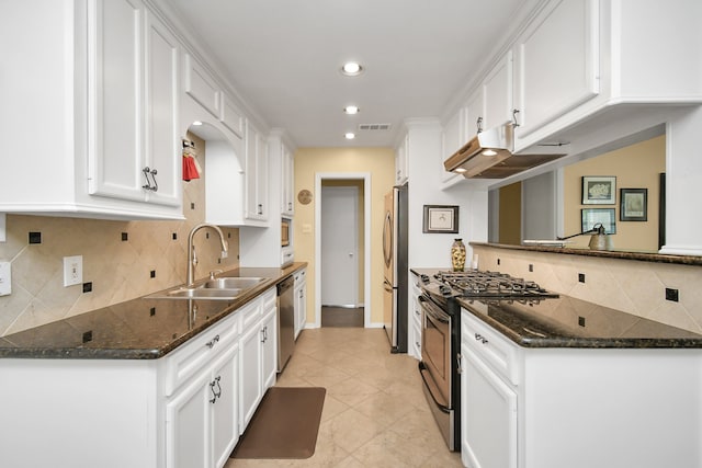 kitchen featuring white cabinets, sink, appliances with stainless steel finishes, and dark stone counters