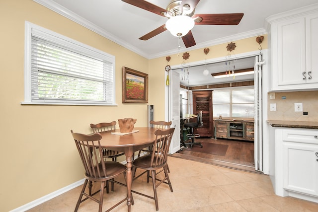 dining room featuring light wood-type flooring, a wealth of natural light, and ornamental molding