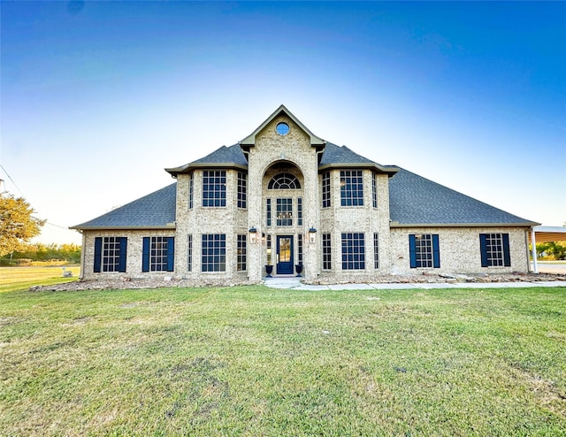 french provincial home featuring a front lawn