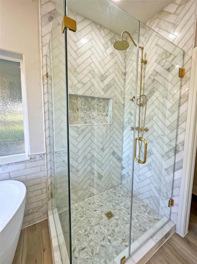 623 Barkaloo Rd, Baytown, TX 77521 - bathroom with a freestanding bath, a shower stall, and wood finished floors