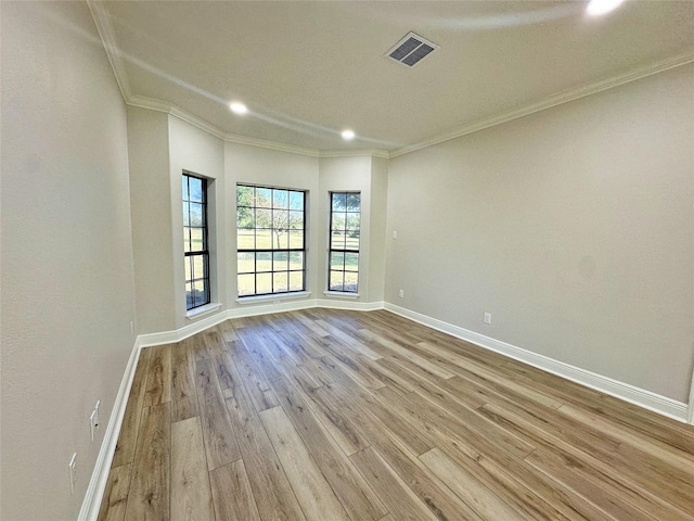 623 Barkaloo Rd, Baytown, TX 77521 - unfurnished room with visible vents, crown molding, wood finished floors, baseboards, and recessed lighting