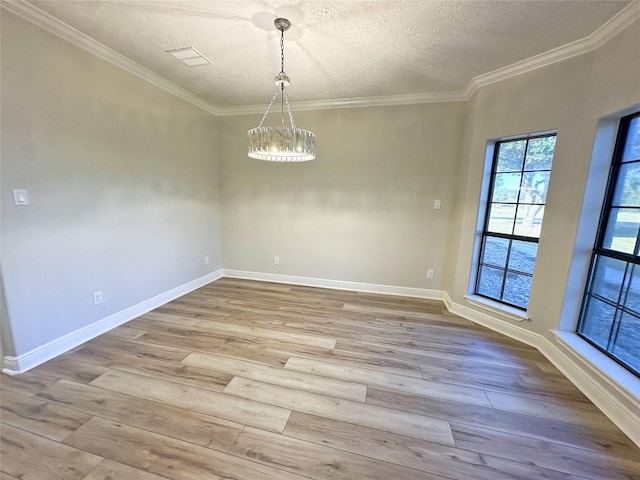 623 Barkaloo Rd, Baytown, TX 77521 - unfurnished dining area featuring a textured ceiling, a notable chandelier, ornamental molding, and wood finished floors