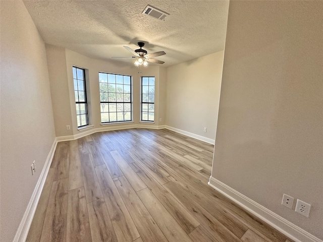 623 Barkaloo Rd, Baytown, TX 77521 - spare room featuring visible vents, baseboards, ceiling fan, and wood finished floors