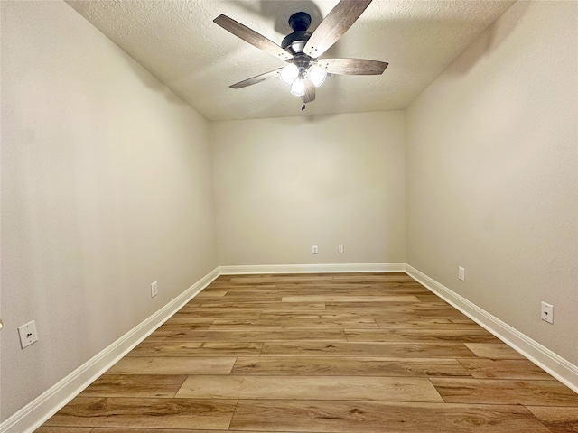 spare room with light hardwood / wood-style flooring, a textured ceiling, and ceiling fan