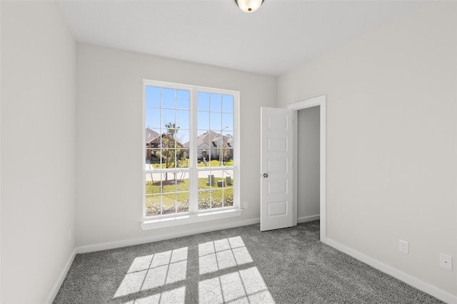 empty room featuring carpet and a healthy amount of sunlight