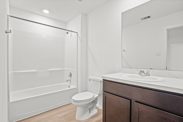 full bathroom with vanity, toilet, wood-type flooring, and tub / shower combination