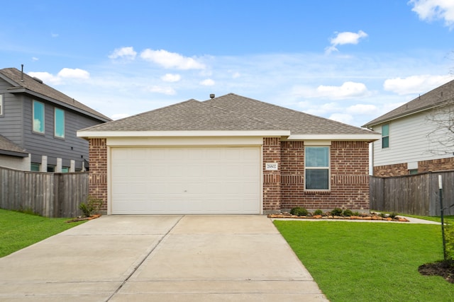 view of front of house featuring a front lawn and a garage