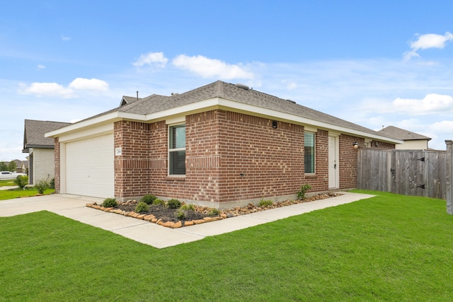 view of side of property featuring a yard and a garage