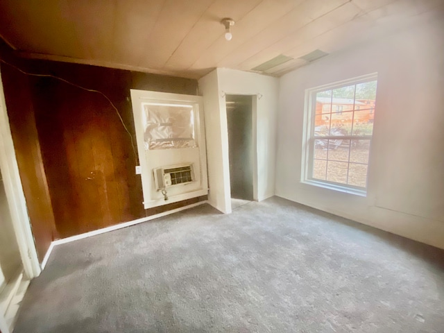 unfurnished living room with carpet and cooling unit