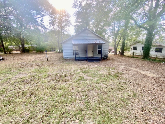 rear view of house featuring a lawn