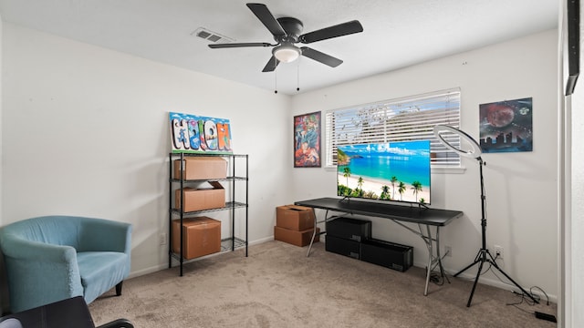 sitting room featuring light colored carpet and ceiling fan