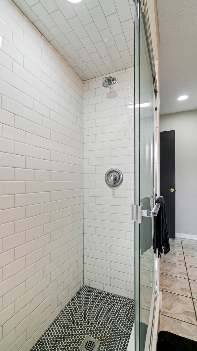 bathroom featuring tile patterned flooring and walk in shower