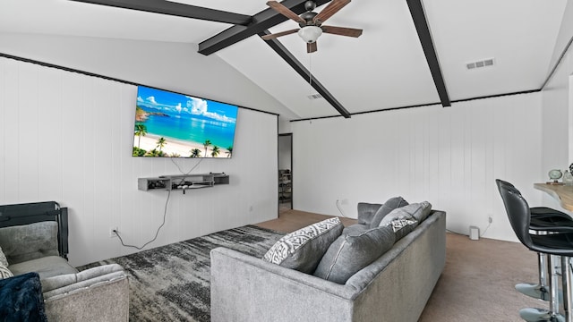 carpeted living room with vaulted ceiling with beams, wooden walls, and ceiling fan