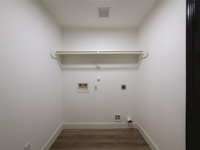 clothes washing area with dark wood-type flooring, washer hookup, gas dryer hookup, and electric dryer hookup