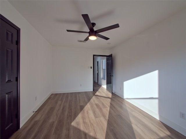 empty room featuring ceiling fan and wood-type flooring