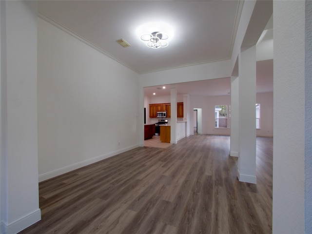 unfurnished living room featuring dark hardwood / wood-style flooring and ornamental molding