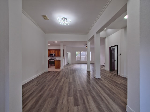 unfurnished living room featuring dark wood-type flooring, ceiling fan, and crown molding