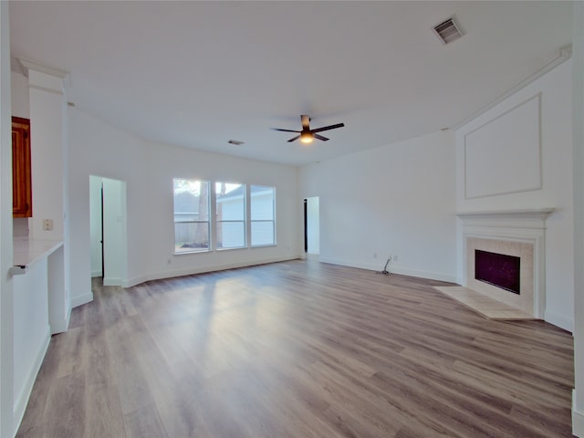 unfurnished living room featuring light hardwood / wood-style flooring and ceiling fan